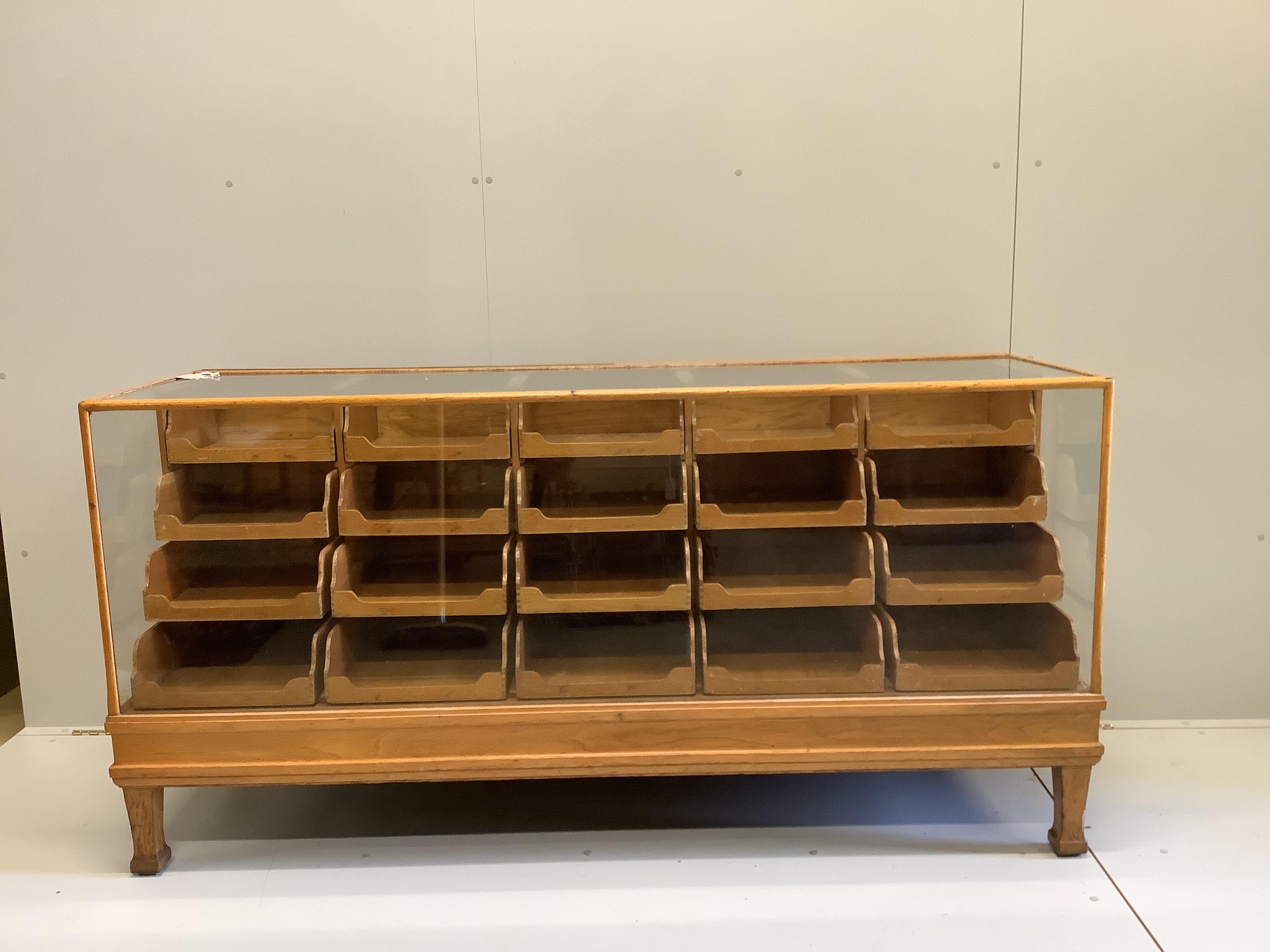 An early 20th century oak haberdashery cabinet, width 180cm, depth 58cm, height 91cm